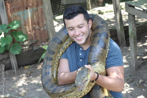 Man with a giant Anaconda around his neck