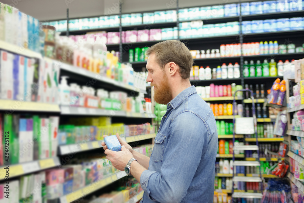 Man near department with tools for body care Man near department with tools for body care