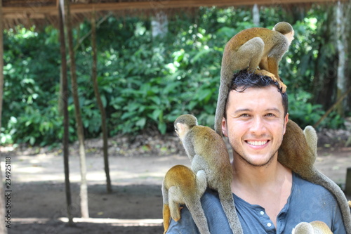 Man and Titi monkeys in the Amazon region 