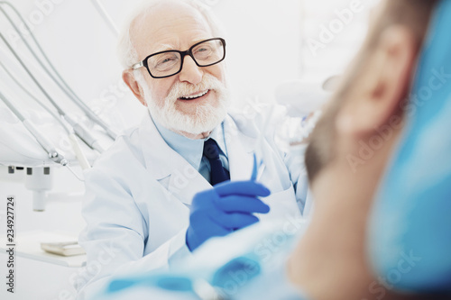 Gay male dentist displaying teeth cleaning