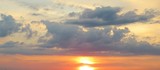  Panoramic view of a beautiful orange sunset with long dark clouds, natural background