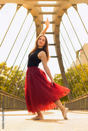 Young slim woman with long brown hair dancing