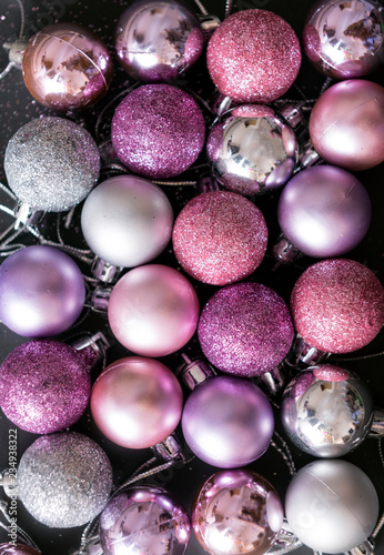  lot of pink and silver Christmas balls on a black background