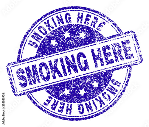 SMOKING HERE stamp seal imprint with grunge texture. Designed with rounded rectangles and circles. Blue vector rubber print of SMOKING HERE label with scratched texture.