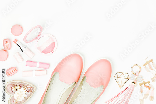 Flat lay of female fashion accessories, shoes, makeup products and handbag on pastel color background. Beauty and fashion concept