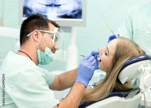 Doctor Dentist with an assistant work in a dental clinic.