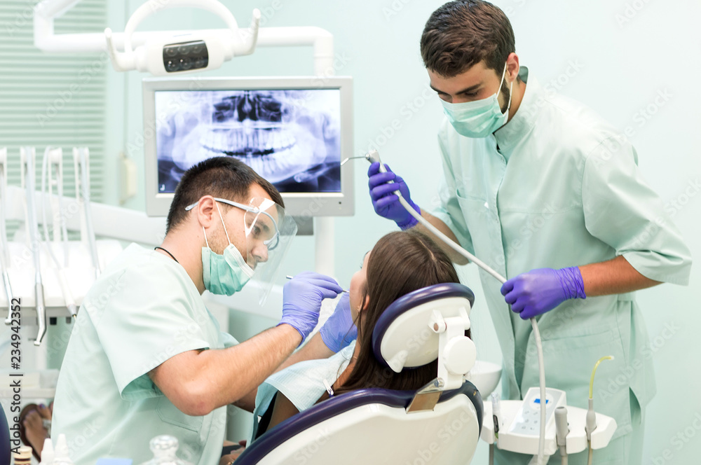 Doctor Dentist with an assistant work in a dental clinic. Doctor Dentist with an assistant work in a dental clinic.