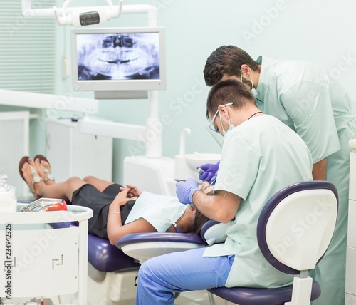Doctor Dentist with an assistant work in a dental clinic.