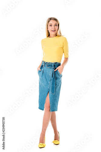 full length view of beautiful surprised girl looking at camera isolated on white