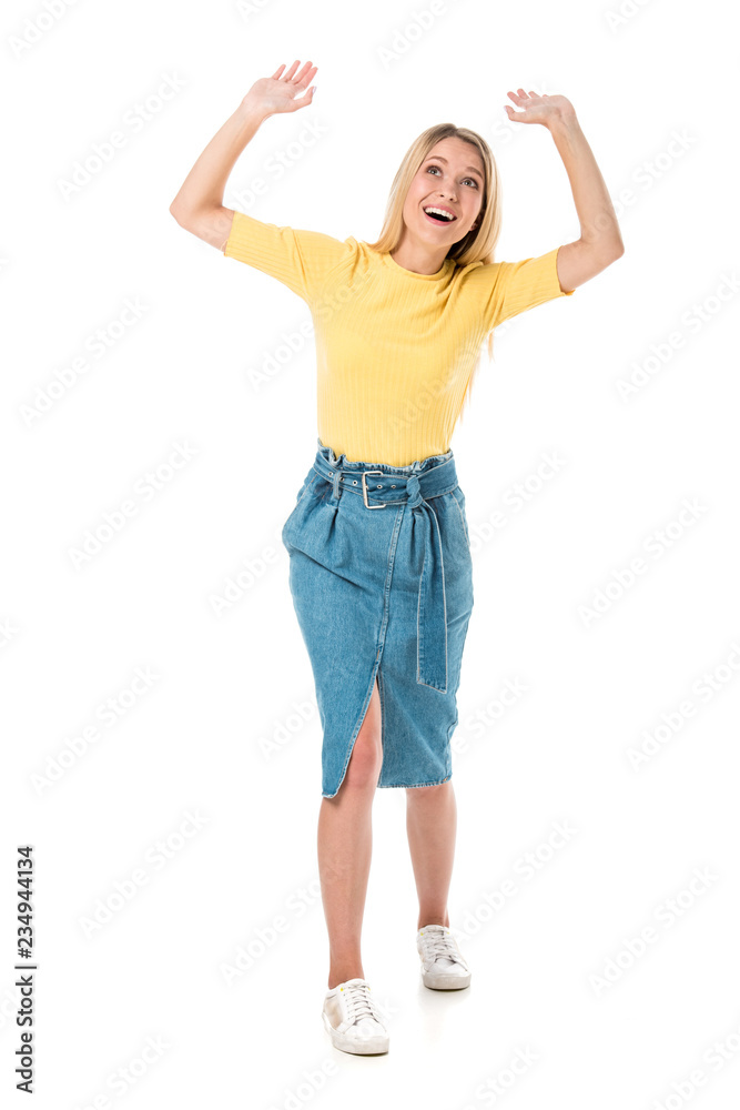 full length view of cheerful young woman raising hands and looking up isolated on white full length view of cheerful young woman raising hands and looking up isolated on white