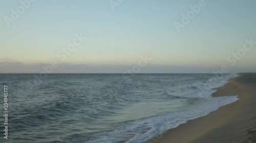 sunrise over the ocean panning from the beach