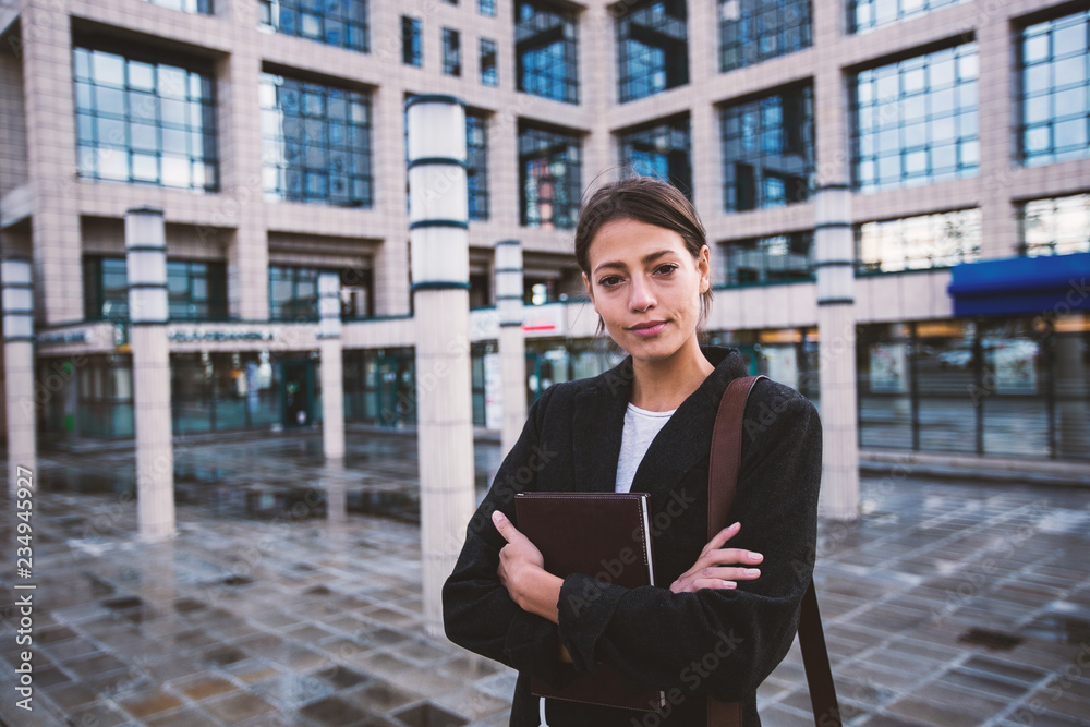 Portrait of young business woman standing near office building Portrait of young business woman standing near office building
