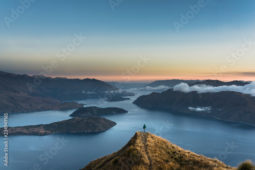 New Zealand, South Island, Wanaka, Otago, Woman on Coromandel peak at sunrise photo