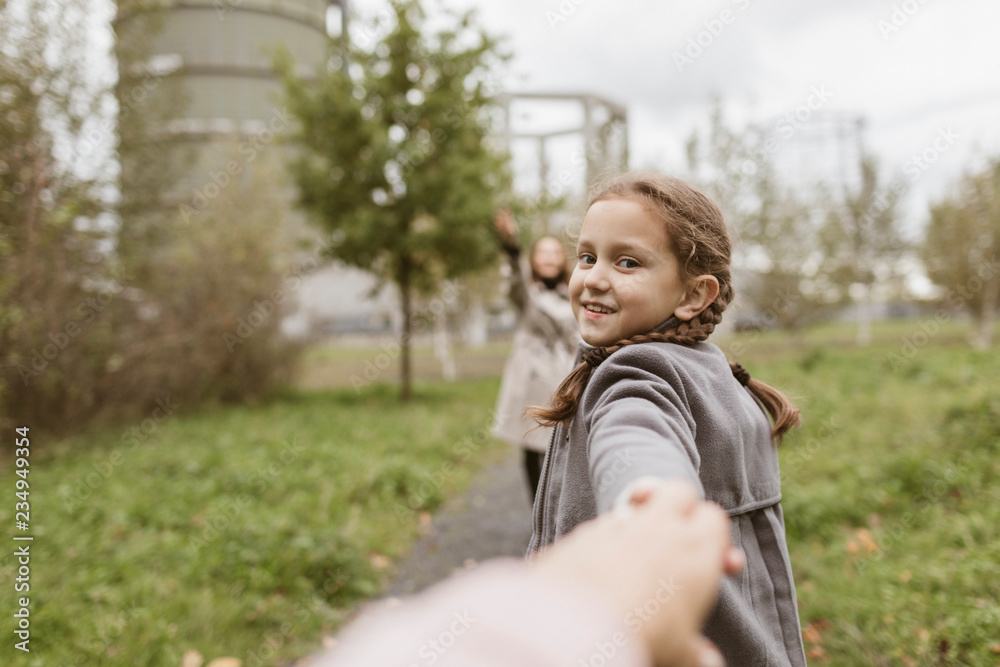 Portrait of smiling girl holding hands outdoors Portrait of smiling girl holding hands outdoors
