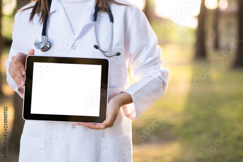 Photography Doctor Using Digital Tablet outdoors