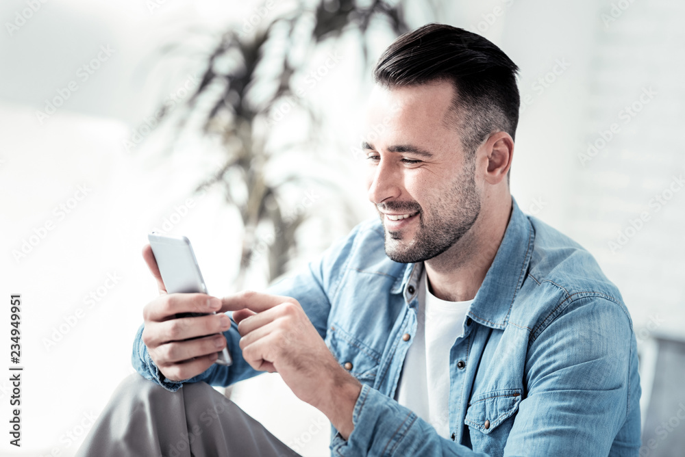 Relaxed young man typing message Relaxed young man typing message