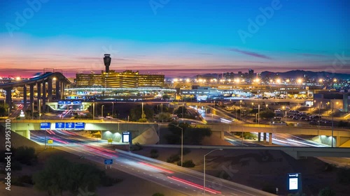 Phoenix Arizona Night Travel Landscape Timelapse with Streaking Lights from Vehicle Traffic Driving Over a Downtown Skyline Background at Dusk photo