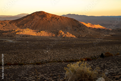 golden morning light on red earth hill  mountains  Eastern Sierra Nevada  California  USA