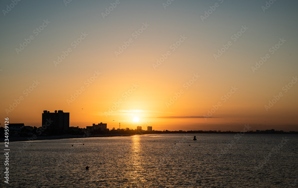 Sunrise over fort myers beach, view from the pier to the east