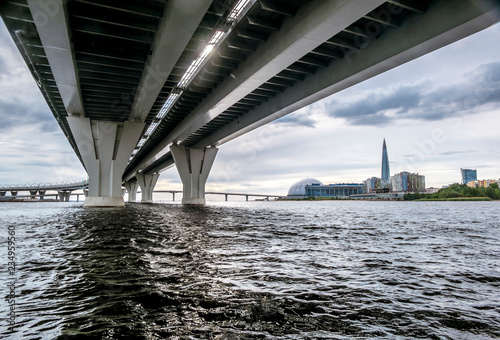 View from the water from under the bridge interchanges ring road to the skyscraper Lakhta in St. Petersburg photo