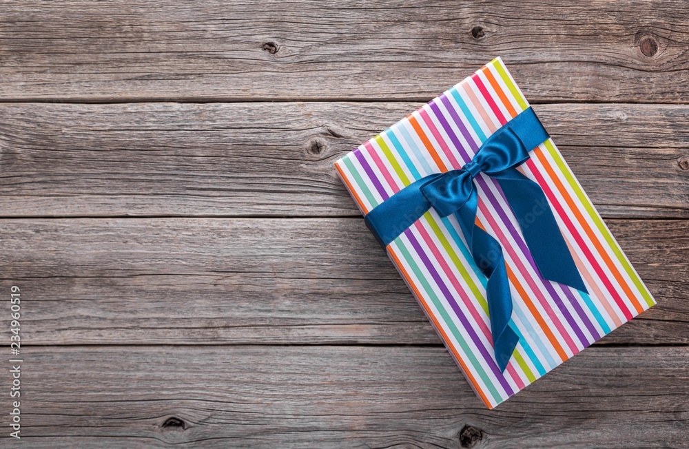 Beautifully packed box lies on wooden boards. Beautifully packed box lies on wooden boards.
