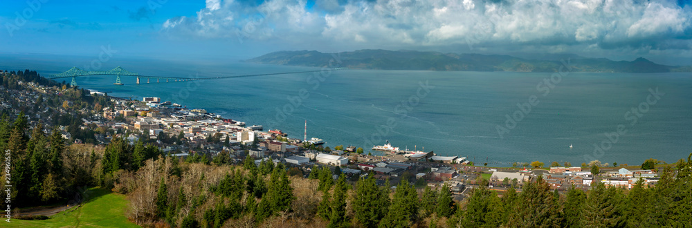 Historic Astoria, Oregon, USA. This view of the Astoria skyline is from the Astoria Column on a hill above the city featuring the beautiful Columbia River and the Astoria–Megler Bridge.