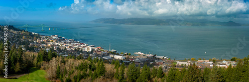 Historic Astoria, Oregon, USA. This view of the Astoria skyline is from the Astoria Column on a hill above the city featuring the beautiful Columbia River and the Astoria–Megler Bridge. photo