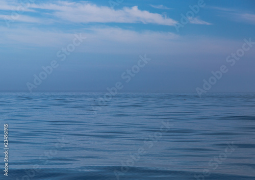 Seascape in blue colors, calm water surface