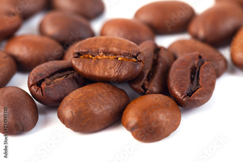 Roasted coffee beans isolated on white background. Three coffee beans