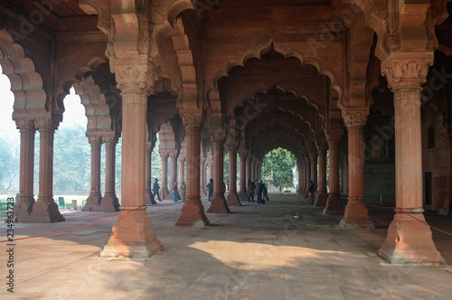 Unidentified people walking inside of Muslim architecture detail of Diwan-i-Am, or Hall of Audience, inside the Red Fort in Delhi, India