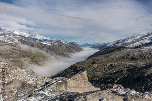 Monte Moro pass from Switzerland into Italy and the Stausee lake near Saas Fee in the southern Swiss Alps