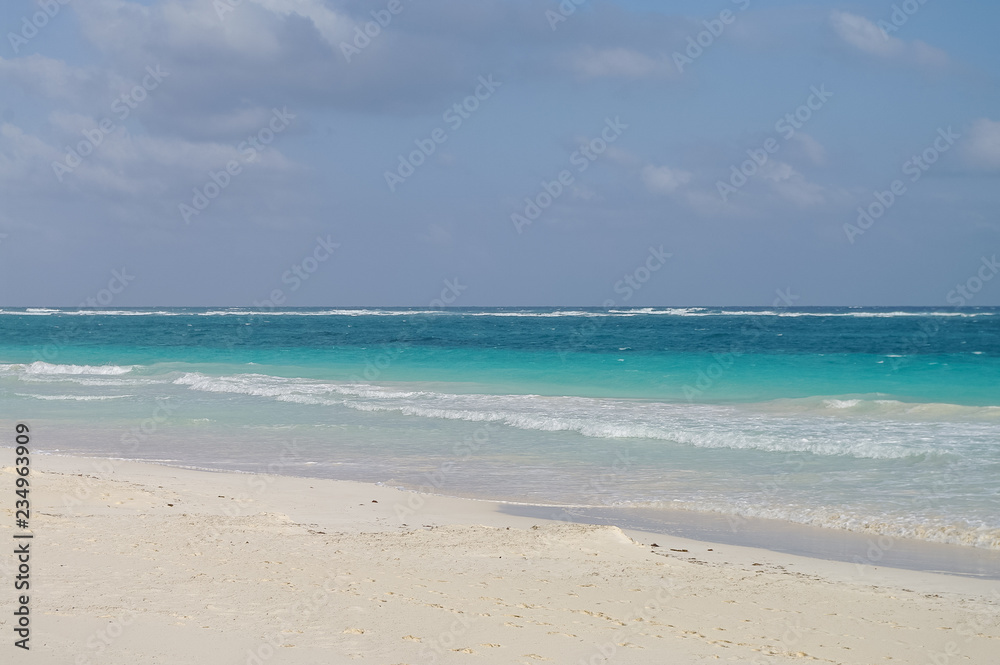 White sand  beach and waves on the coast of the Caribbean Sea, Mexico. Riviera Maya