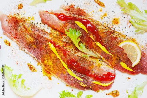 Raw meat, beef steak with spices on whhite background, top view photo