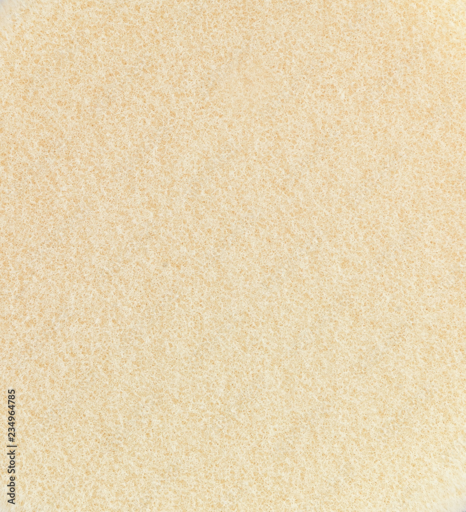 Yellow sponge texture background, close up view of a cosmetic sponge or pad for facial make up Yellow sponge texture background, close up view of a cosmetic sponge or pad for facial make up