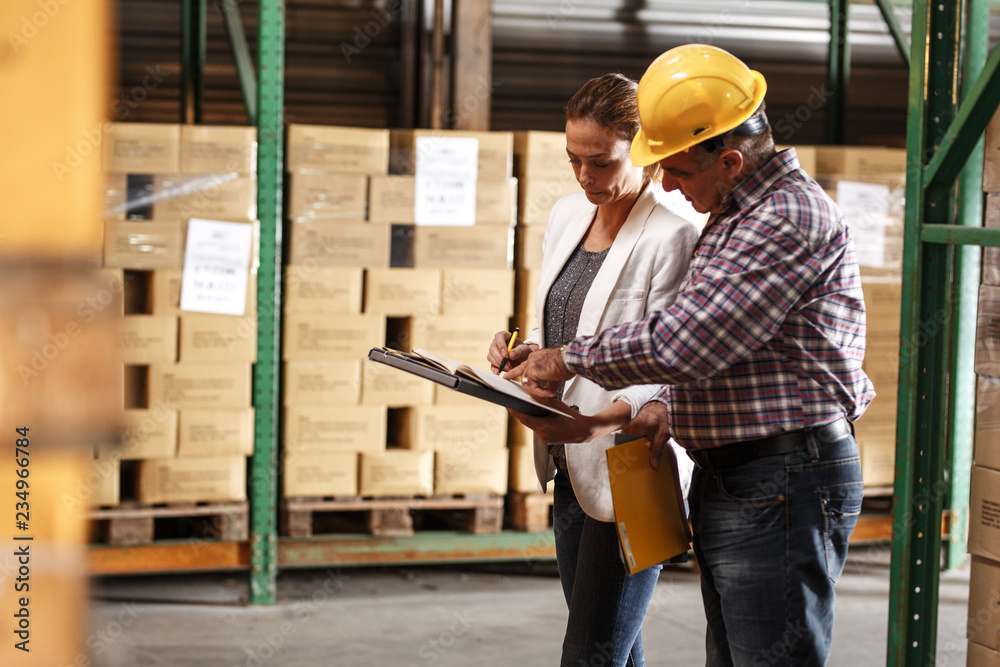 Female manager and warehouse worker checking list and inventory on the shelf in storehouse. Female manager and warehouse worker checking list and inventory on the shelf in storehouse.