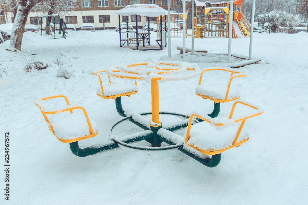 Snow-covered children's carousels at the playground Snow-covered children's carousels at the playground