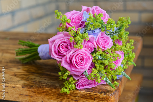bridal bouquet of fresh roses on the table. wedding floristry  floristic decorative statement