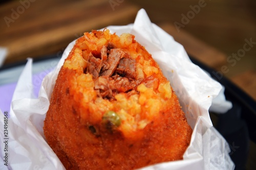 Arancino, typical sicilian street food made with rice photo