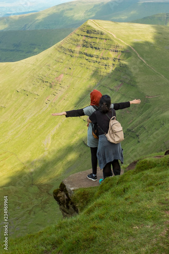 two women stand and admire the views on Fan Y Big Diving Board,  Pen Y Fan, Breacon Beacons Natioal Park, Wales photo