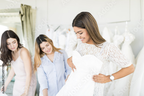 Attractive Bride Choosing A Wedding Dress In The Store