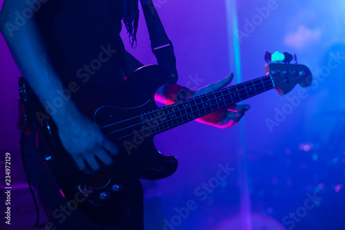 Live rock music background, bass guitar player