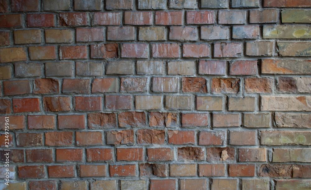 Old brick wall with deteriorated parts.