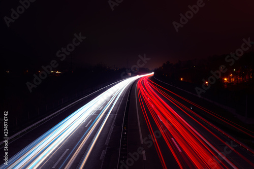 Light trails of cars at night on a highway