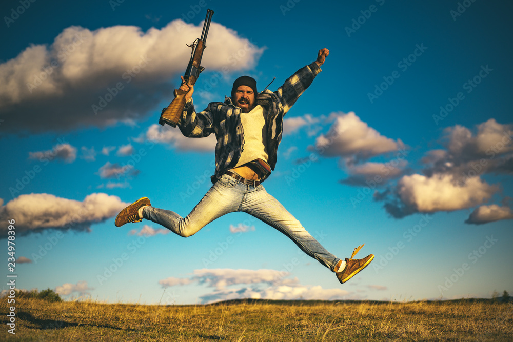 Hunter with shotgun gun on hunt. Crazy hunter on sky background. Stock  Photo