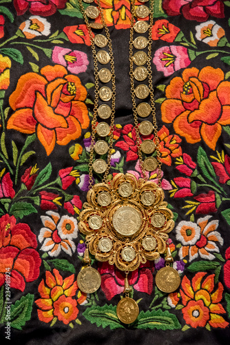 bordado tradicional mexicano de oaxaca, traje del itsmo de tehuantepec  con collar de oro de monedas y centenarios photo