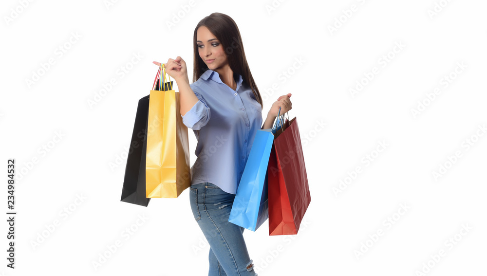 Shopping and Lifestyle Concept: Young cheerful woman holding colorful shopping bag
