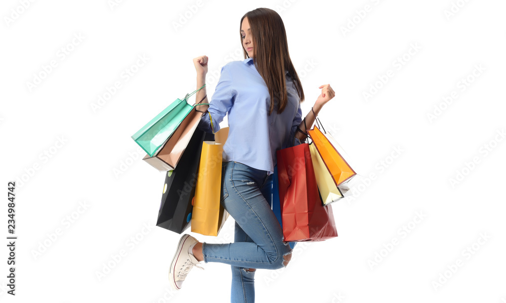Shopping and Lifestyle Concept: Young cheerful woman holding colorful shopping bag Shopping and Lifestyle Concept: Young cheerful woman holding colorful shopping bag