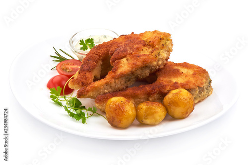 Fried Batterer Fish Fillet with herbs, sauce and potatoes, isolated on a white background. Close-up