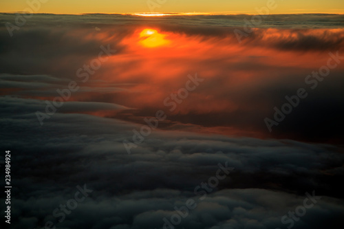 Clouds view from the airplane  Flying over the evening timelapse clouds with the late sun. Flight through moving cloudscape with beautiful sun rays. Traveling by air. Perfect for cinema  background