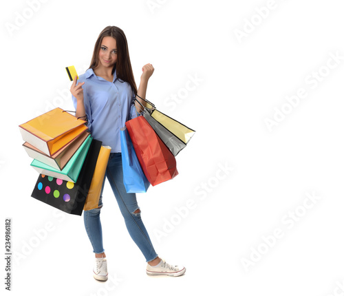 Shopping and Lifestyle Concept: Young cheerful woman holding colorful shopping bag. Isolated over white background.